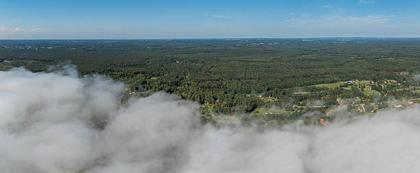 istock Aerial View of Forested Landscape with Clouds and Rural Features 2225165900