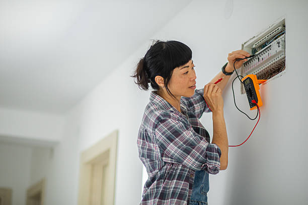 istock Focused woman using a digital multimeter to measure voltage or test connections inside a home electrical panel 2225166025