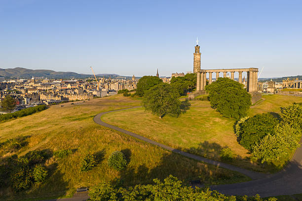 Aerial image of the iconic Calton Hill with Edinburgh cityscape on the background photographed in the morning.