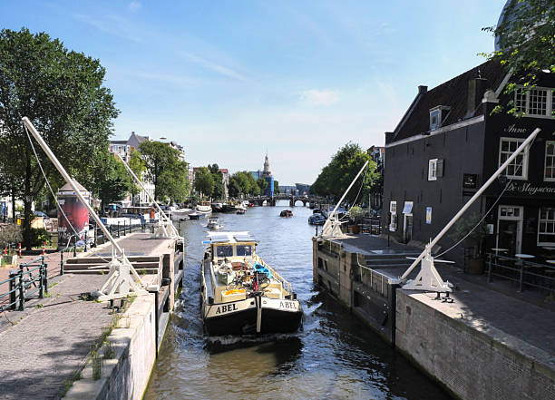 Holland Casino building and boat in canal in the city of Amsterdam