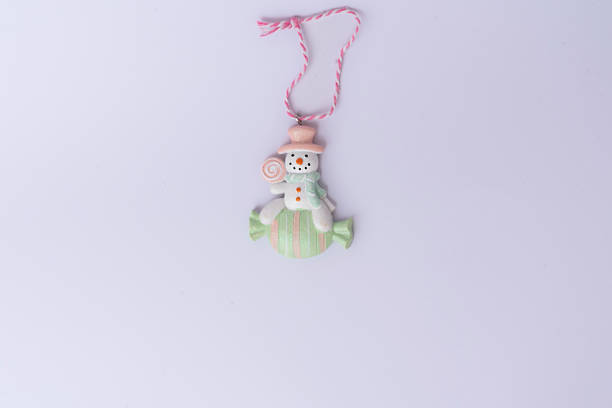 Cute Christmas snowman toy isolated on a white background. Perfect for festive designs, New Year greetings, and holiday decorations. Seasonal and cheerful concept.