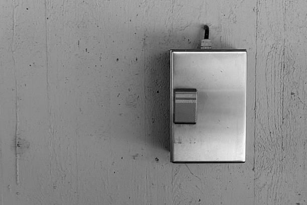 istock Metal switch plate on a textured wall illuminated by soft light brings a modern touch to minimalistic design aesthetics in a cozy space 2225169097