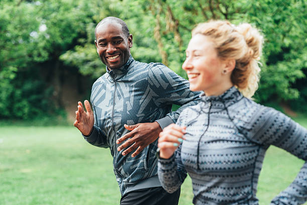 istock Cardio training outdoors. Happy athletic couple having fun while running together in nature. 2225169426