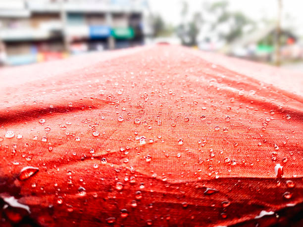 Rain drops on a red umbrella. Raindrops on an umbrella.