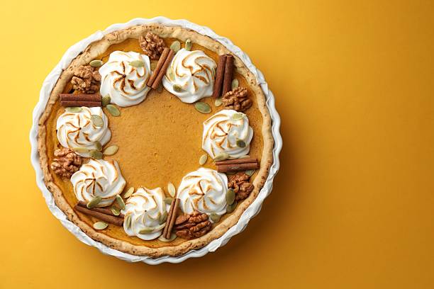 istock Tasty homemade pumpkin pie in baking dish on orange table, top view. Space for text 2225172404