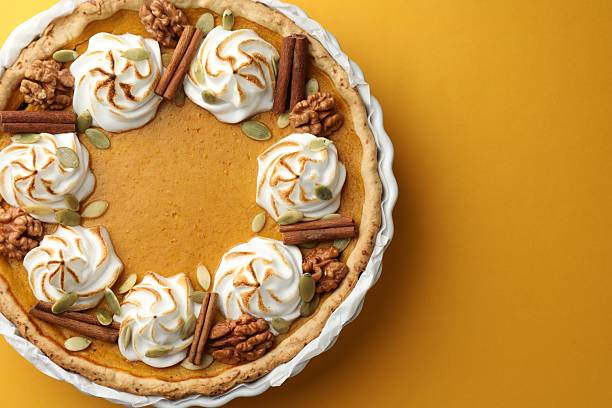 istock Tasty homemade pumpkin pie in baking dish on orange table, top view. Space for text 2225172500