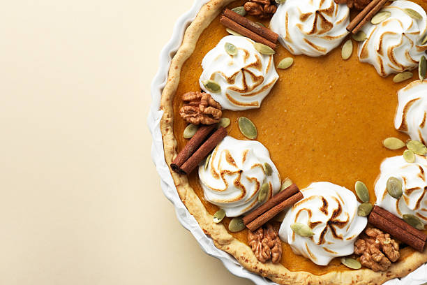 istock Tasty homemade pumpkin pie in baking dish on beige table, top view. Space for text 2225172586