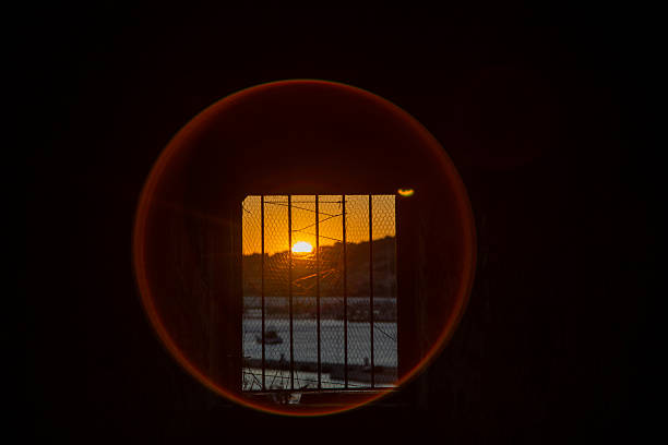 istock Sunset Over Sea and Mountains Seen Through Barred Window 2225173273