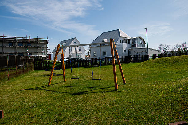 istock Wooden swing set on a lawn in Akranes under a bright blue sky 2225176716