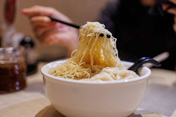 istock Wonton noodle soup served in white bowl 2225177864