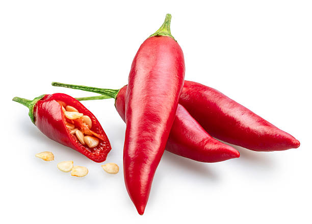 Fresh red chilli peppers and chilli slices and seeds isolated on white background. File contains clipping paths.