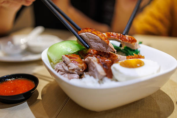 a photography of a plate of food with meat, rice and broccoli.