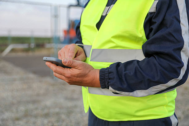 istock Oil Field Worker Using Smartphone Near Pumpjack 2225178637