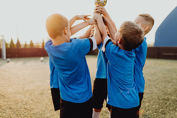 istock Junior football team celebrating victory 2225179905