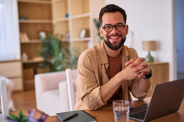 istock Young businessman smiling and working from home using laptop 2225180054