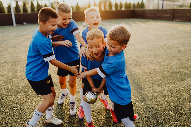 istock Junior football team celebrating victory 2225180090