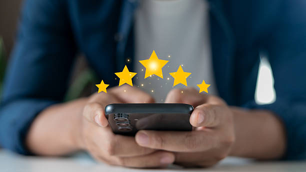 istock User giving five-star rating on smartphone, representing positive customer feedback, user experience review, and online service satisfaction. 2225184087