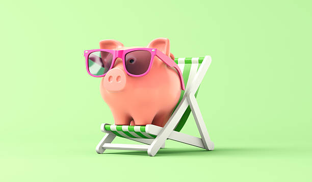 istock Pink piggy bank sat in a deckchair 2225184287
