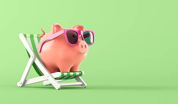 istock Pink piggy bank sat in a deckchair 2225184288
