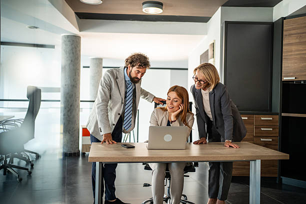 istock Business team collaborating on laptop in modern office 2225186345