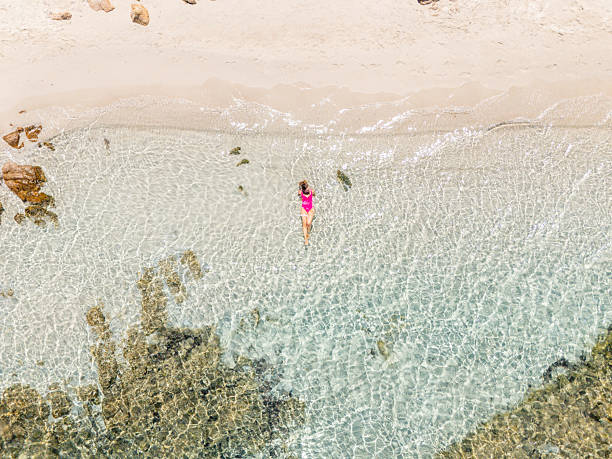 istock Woman Relaxing in Shallow Clear Beach Water 2225188077