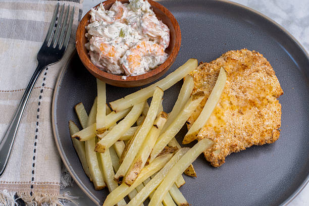 istock baked cod with  fries and  shrimp seafood salad 2225188493