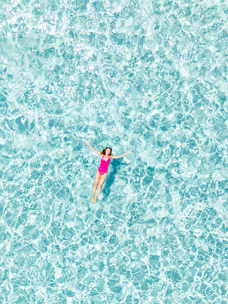 istock Woman Floating Relaxed in Clear Blue Water 2225188642