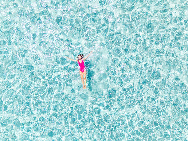 istock Woman Floating Relaxed in Clear Blue Water 2225188649
