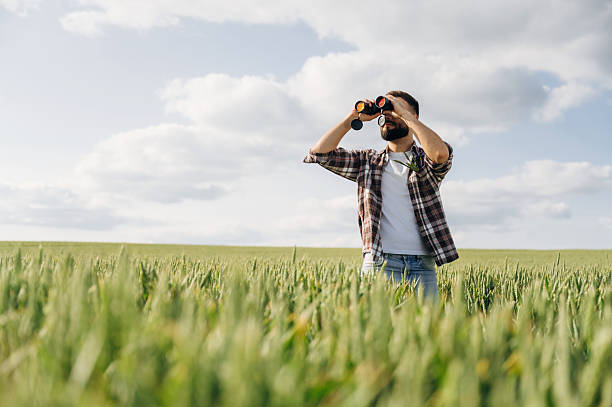 istock Using binoculars. Man farmer is on the agricultural field 2225189289