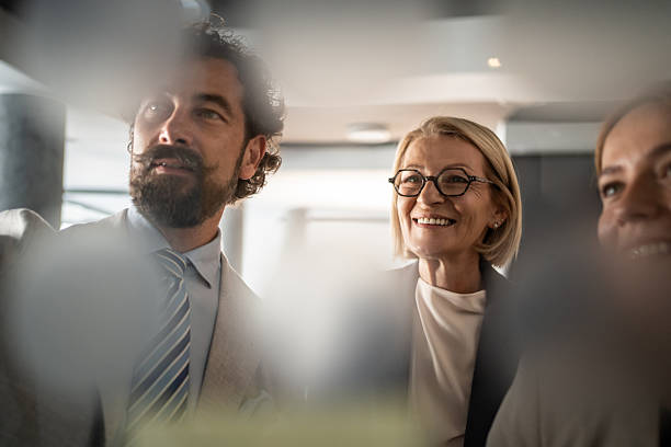 istock Business team looking up and smiling during a meeting 2225189500