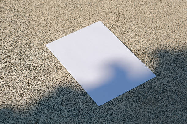 istock empty vertical paper poster mockup on concrete stone floor or pavement outdoors, shadow overlay 2225189962