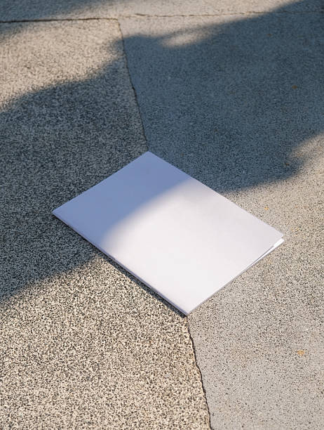 istock empty magazine mockup on concrete stone floor or pavement outdoors, shadow overlay 2225190118