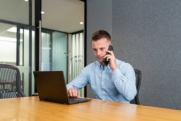 istock Focused Businessman on Call While Working on Laptop 2225190155
