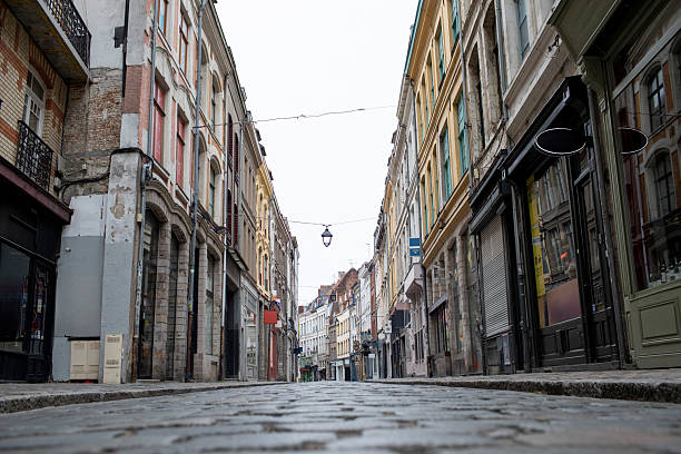 istock Empty cobblestone street of shops in Lille old town viewed from a low angle 2225190325