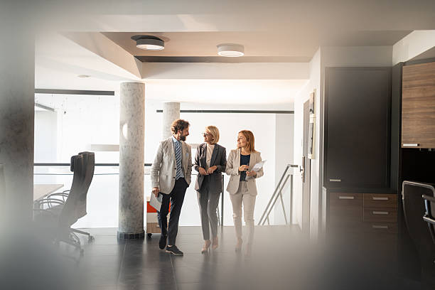 istock Businesspeople walking and talking in modern office 2225190737