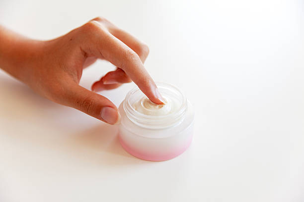 Close-up of Hand touching on cream moisturizer product