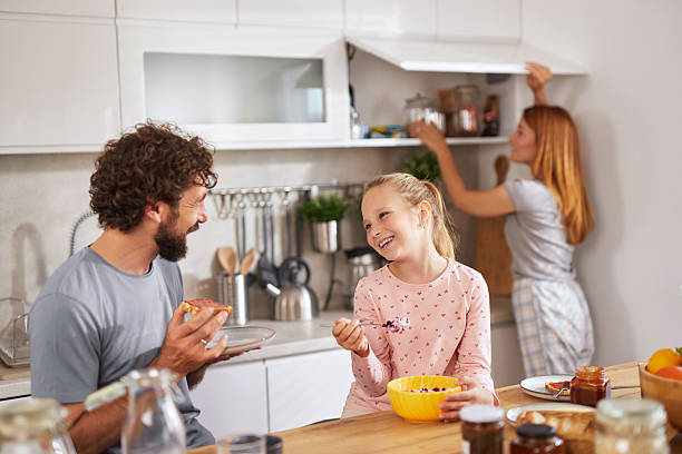 istock Happy family having breakfast together in a modern kitchen 2225195113