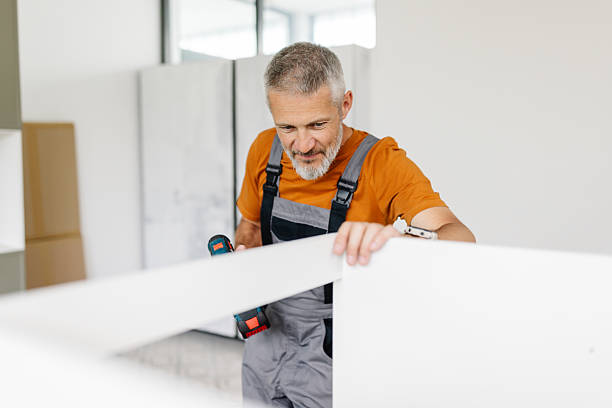 istock Focused Man Using Drill on White Furniture Piece 2225198518