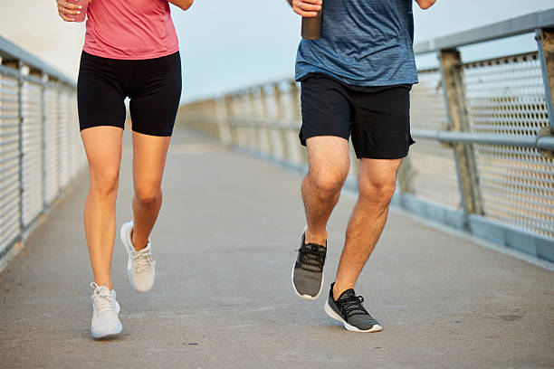 istock Couple running outdoors on a bridge, maintaining a healthy lifestyle 2225206258
