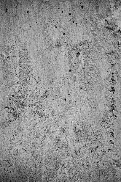 istock Textured grey concrete wall surface with details and imperfections visible 2225206817