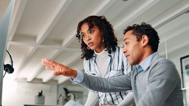 istock Help, call centre and business people in workplace, computer or conversation with mentor. Employees, agent or consultant with pc, website info or cooperation with sales agency, internet or discussion 2225207035
