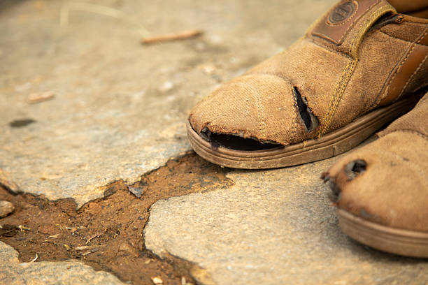 Pair of old working boots on black