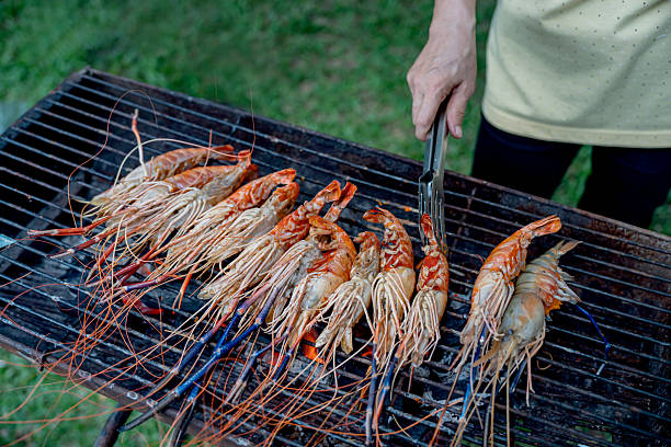 Cooking BBQ fresh prawns at camping. Grill fresh seafood for dinner.