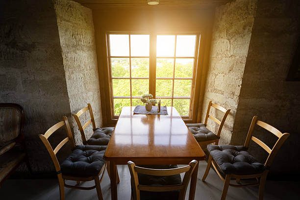 Room with stone walls and sunlight through vintage window.
