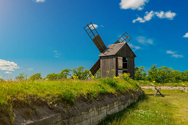 Traditional wooden windmill in countryside.