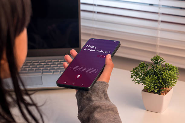 istock A young girl holding a smartphone to use virtual voice assistant 2225211912