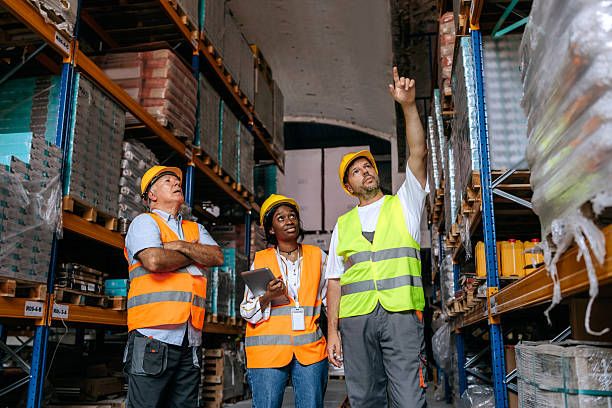 istock Team discussion among warehouse workers by storage shelves 2225213116