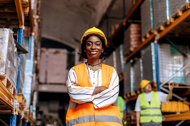 istock Female warehouse worker posing for camera at storage room 2225213172