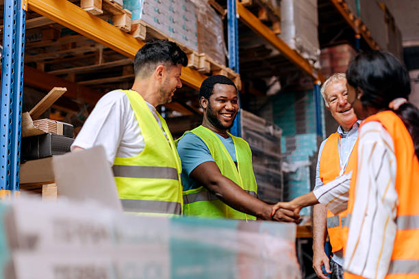 istock Warehouse coworkers shaking hands 2225213381