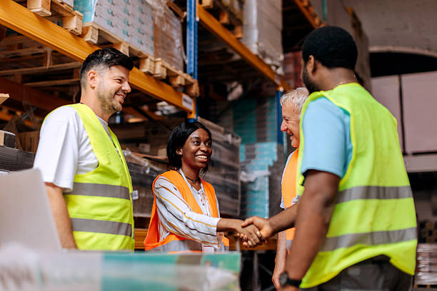 istock Warehouse coworkers shaking hands 2225213501